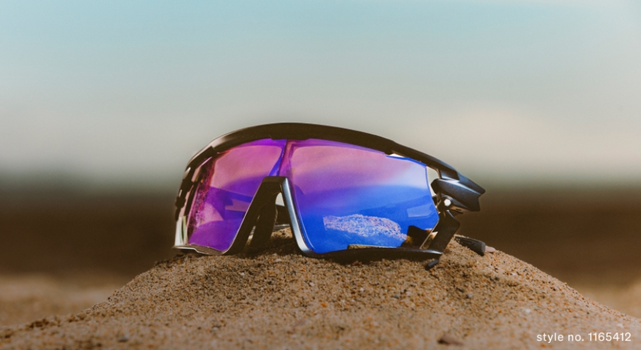 Sports sunglasses with reflective purple lenses on sand, style no. 1165412.