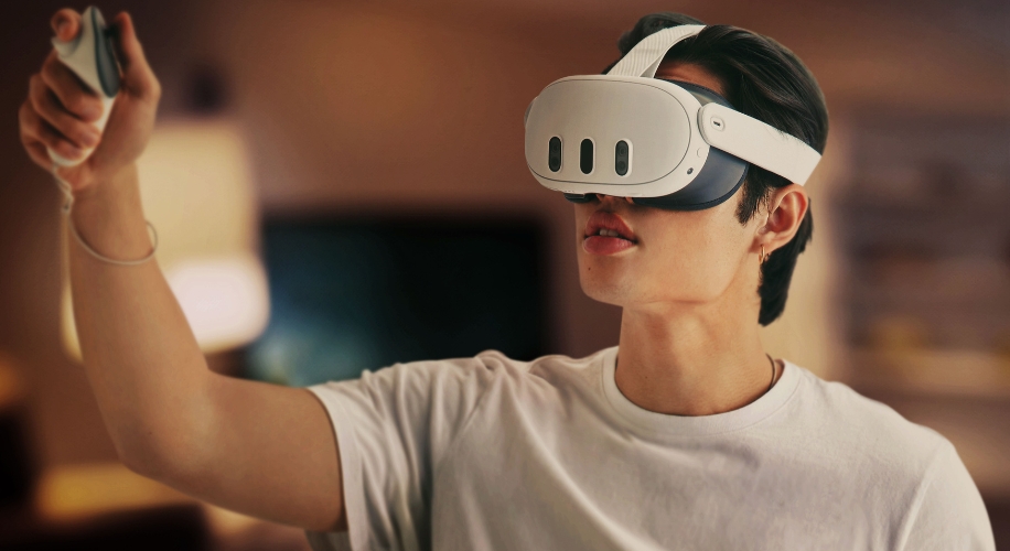 Man using a virtual reality headset and handheld controller.