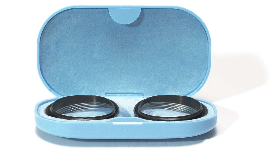 Open blue contact lens case with two black contact lens holders inside.