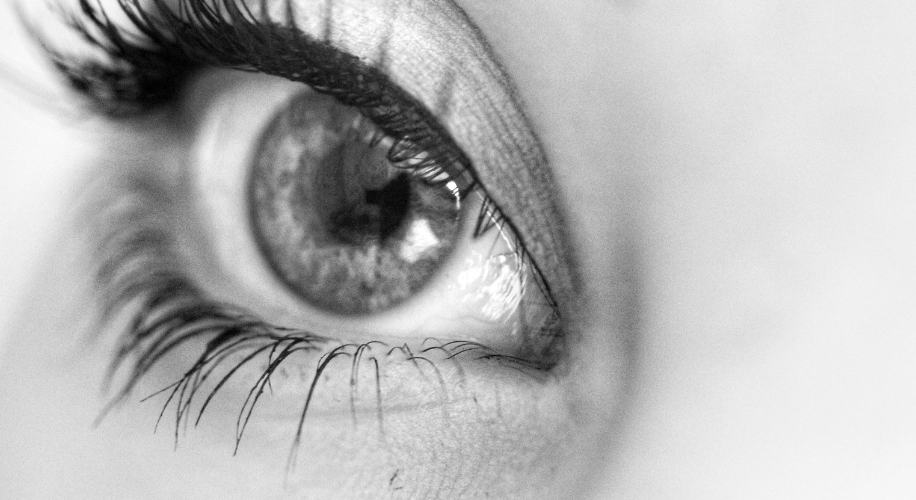 Close-up of an eye with long eyelashes and prominent eyeliner.