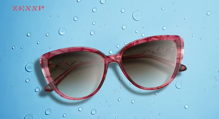 Zenni red cat-eye sunglasses with gradient lenses on a blue background with water droplets.