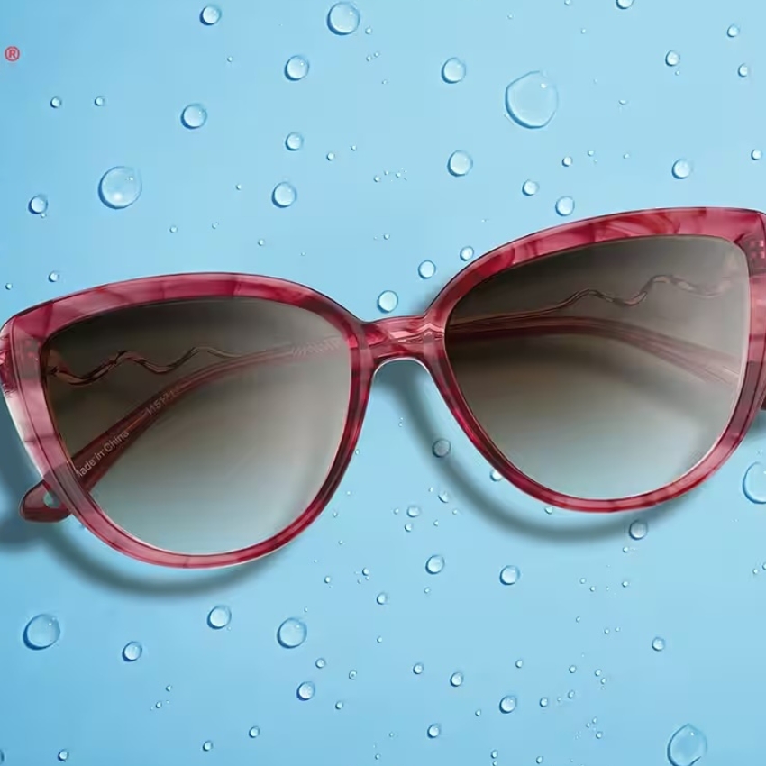 Pink oversized cat-eye sunglasses with gradient dark lenses, text on the inner arm reads "Made in China".