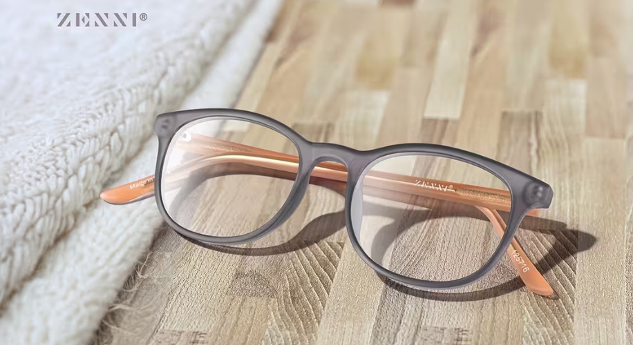 Zenni eyeglasses with gray frames and orange temples, engraved &quot;ZENNIE&quot; on the temples.