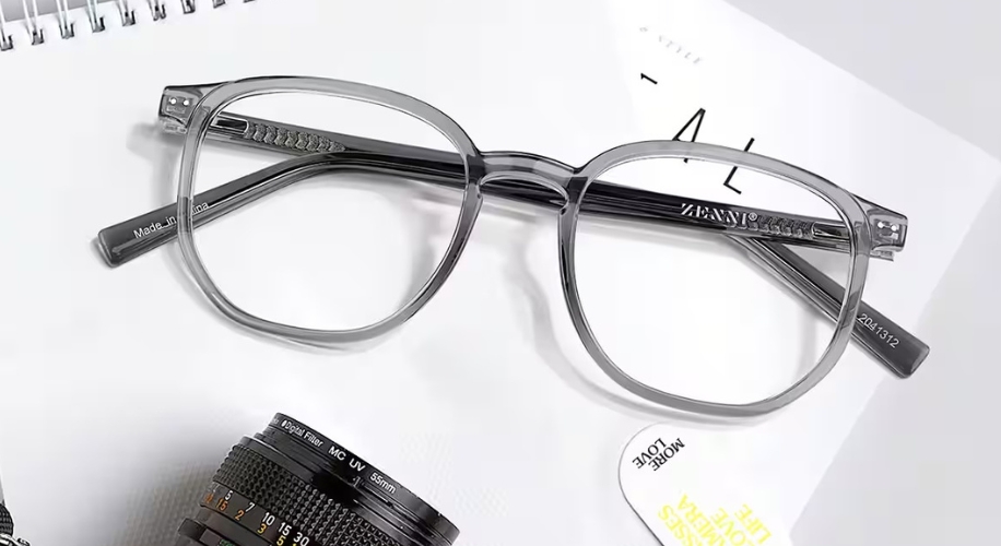 Clear-framed eyeglasses with text on the arms reading &quot;Made in PRC&quot; and &quot;ZENNI&quot;.