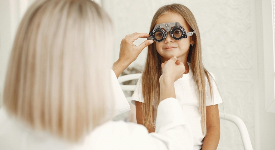 Child undergoing an eye examination with a phoropter.