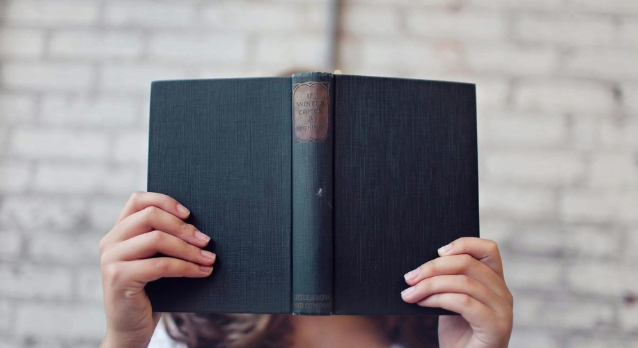 Person holding a dark green book titled &quot;The Winter Comes&quot; by Hutchinson. Published by Little, Brown and Company.