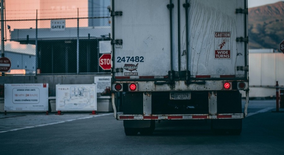 Truck rear with license plate U723179, 247482, &quot;Caution Wide Turns&quot; and &quot;Wabash Duraplate&quot; stickers.