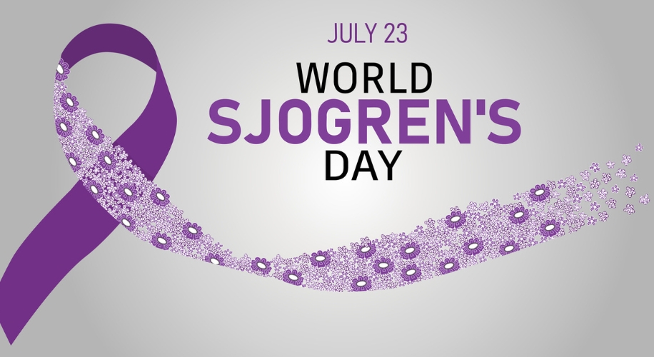 Purple ribbon with flowers and text &quot;July 23 World Sjogren&#039;s Day&quot; on a gray background.