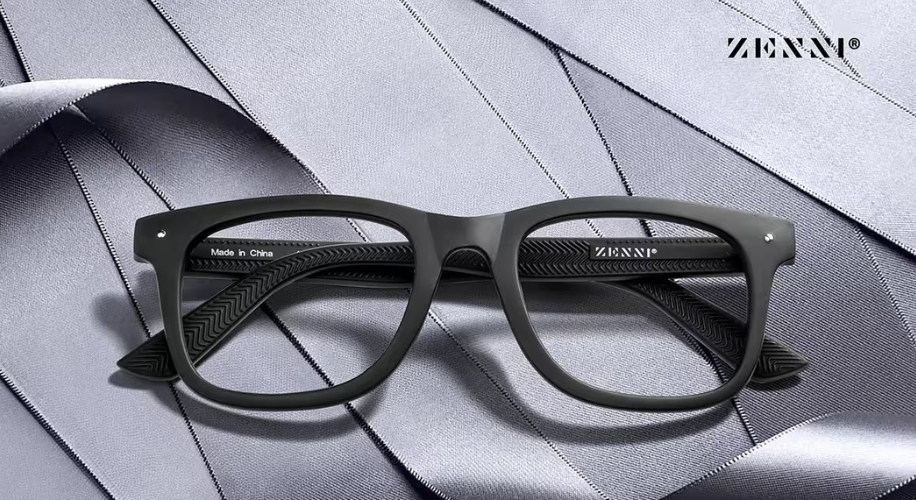 Black eyeglasses with text on the inner arm saying &quot;Made in China.&quot; Zenni branding on the arms and top right.