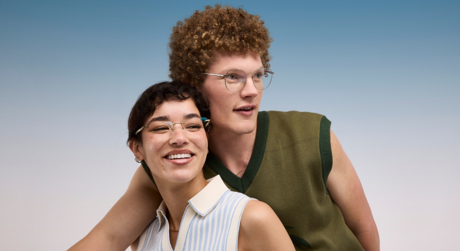 Two people wearing stylish, modern eyeglasses and casual clothing, smiling and looking happy together.