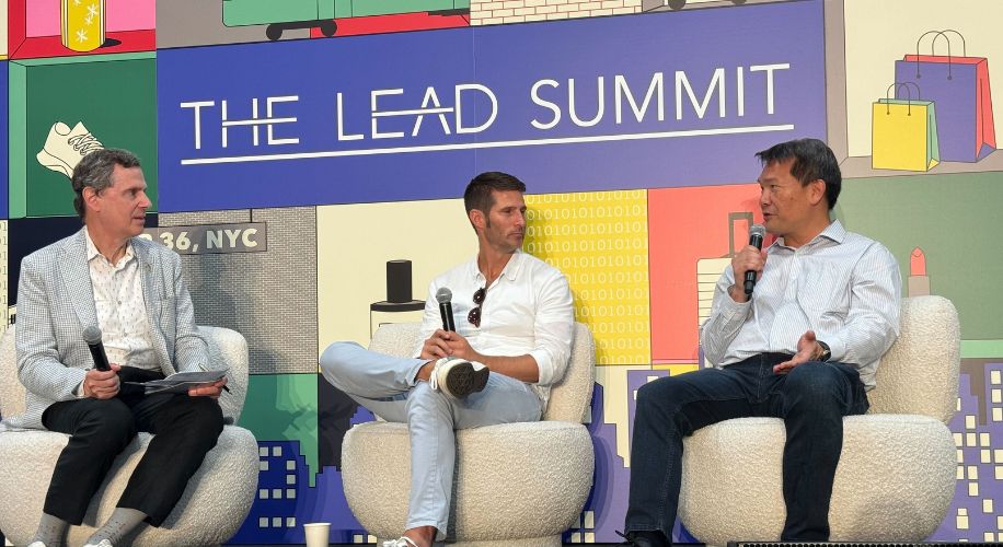 THE LEAD SUMMIT. Three men seated on stage discussing, holding microphones. Event in NYC, 2023.