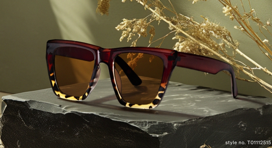 Red and tortoiseshell sunglasses with brown lenses. Text: style no. T01112515.