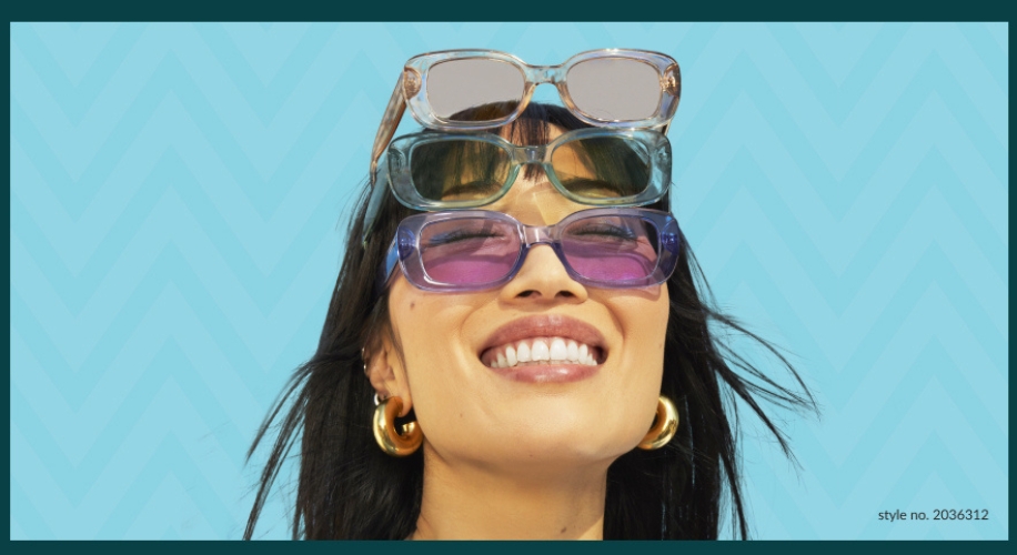 Woman smiling while balancing four pairs of sunglasses on her forehead. Style no. 2036312