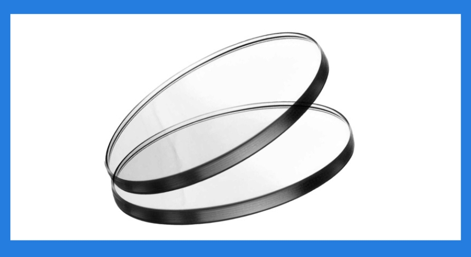 Two clear, round glass lenses with black borders, stacked and slightly tilted against each other.