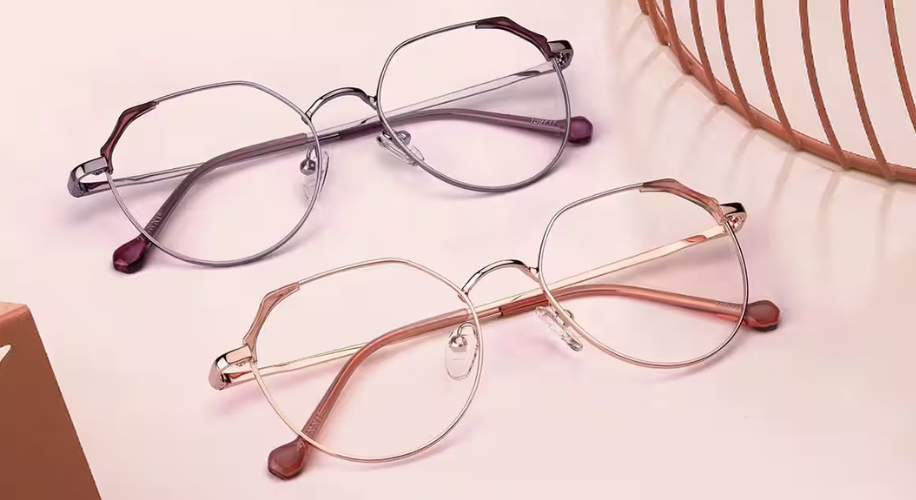 Two pairs of metal-framed eyeglasses with round lenses, one in silver and the other in gold.