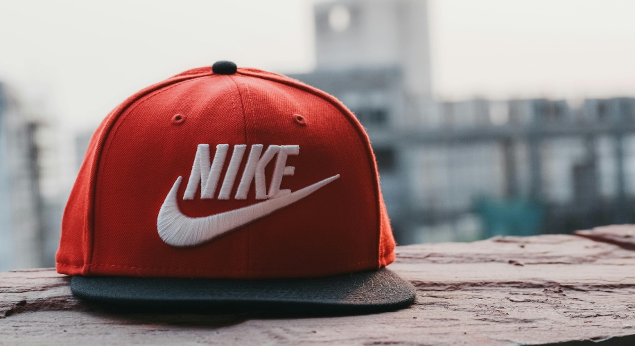 Red Nike cap with black brim, featuring the white Nike logo and text.