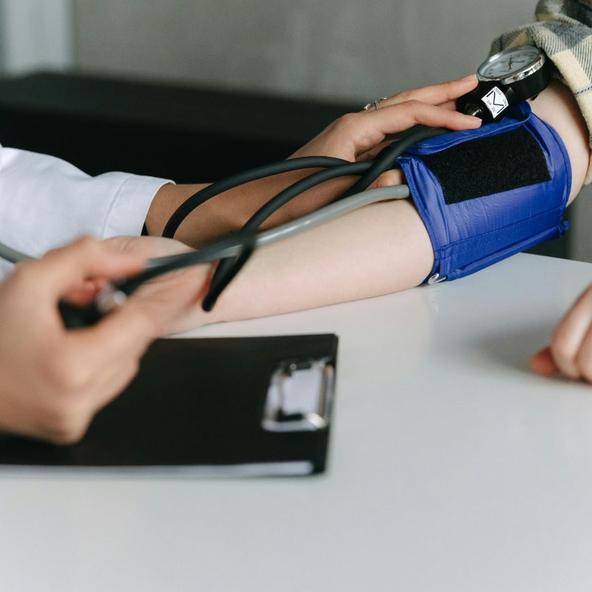 A blood pressure monitor is being used on a person’s arm.