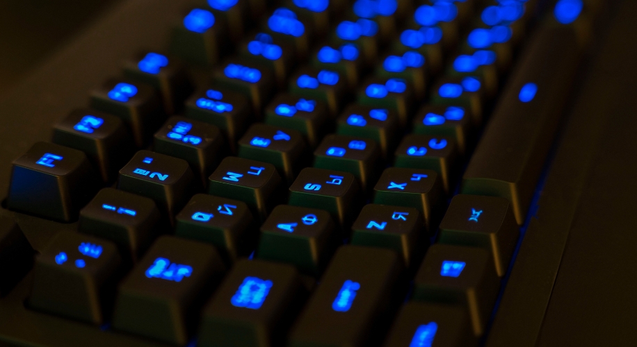 Black keyboard with blue backlit keys.