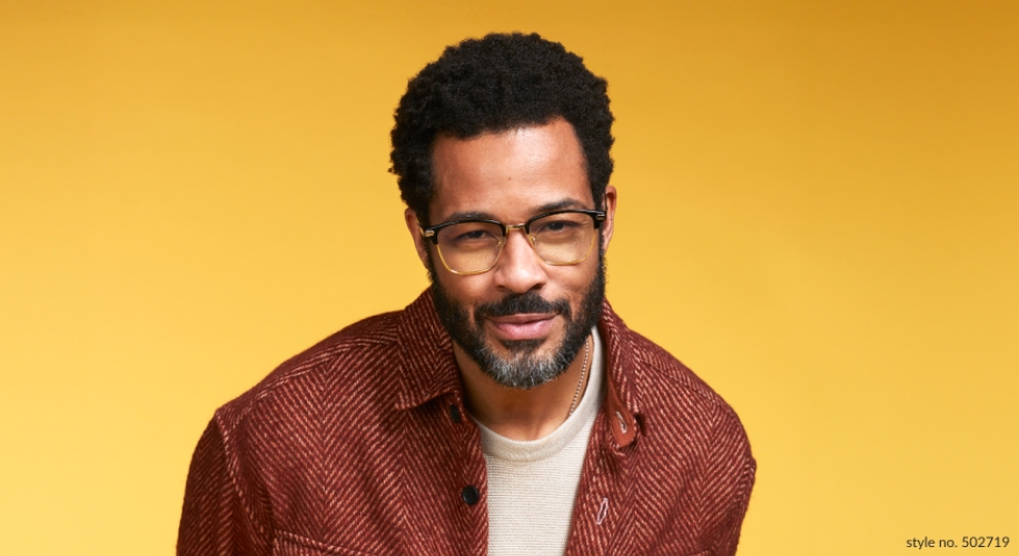 Man wearing glasses, a cream-colored shirt, and a brown jacket. Text: style no. 502719.