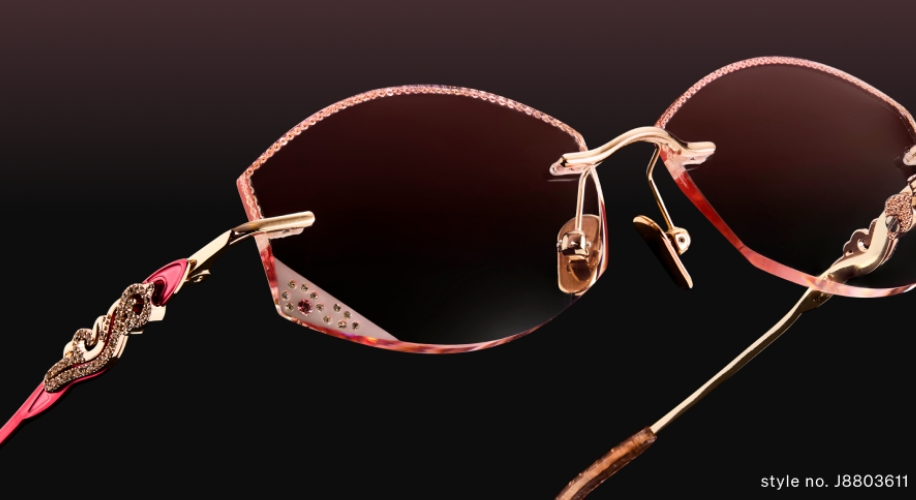 Elegant sunglasses with pink-tinted lenses and intricate gold detailing. Style no. J8803611.