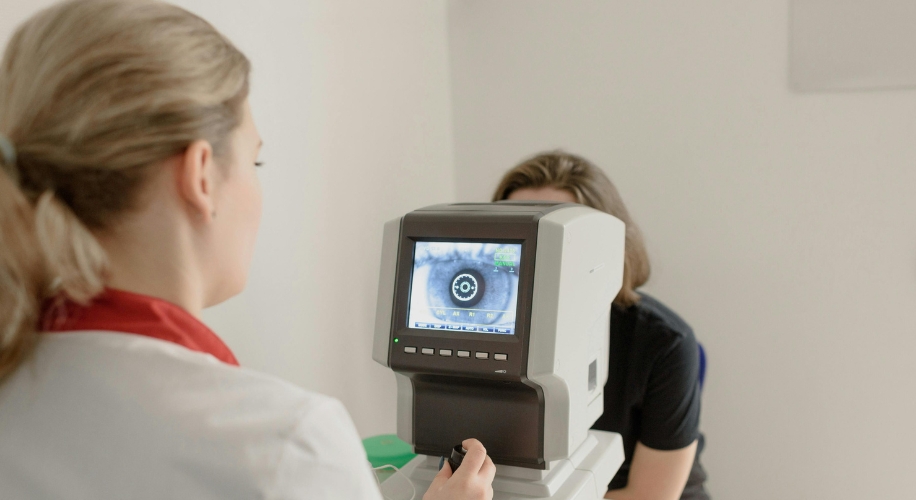 Optometry device displaying an iris scan, being used by a healthcare professional.