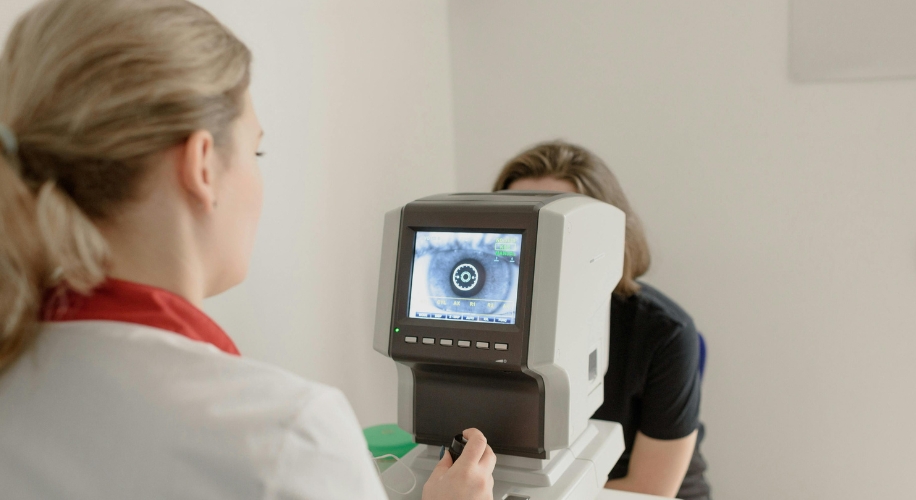 Eye examination with an optical device focusing on a patient&#039;s eye.