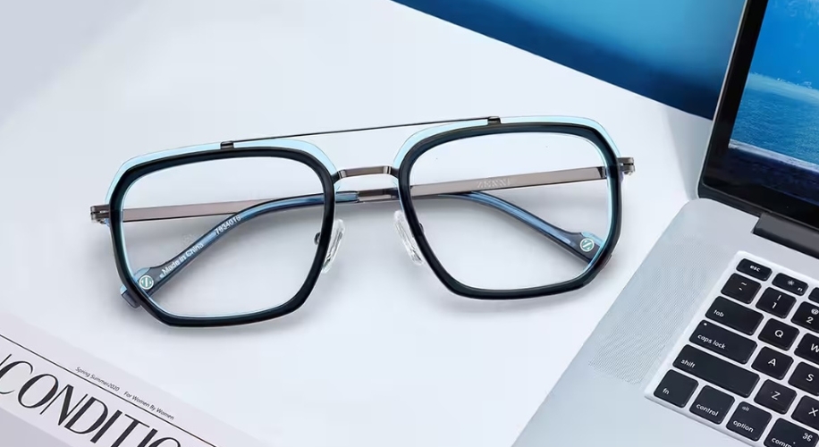 Blue square eyeglasses with blue-tinted lenses and silver bridge temples labeled &quot;Naturevibe Green.&quot;