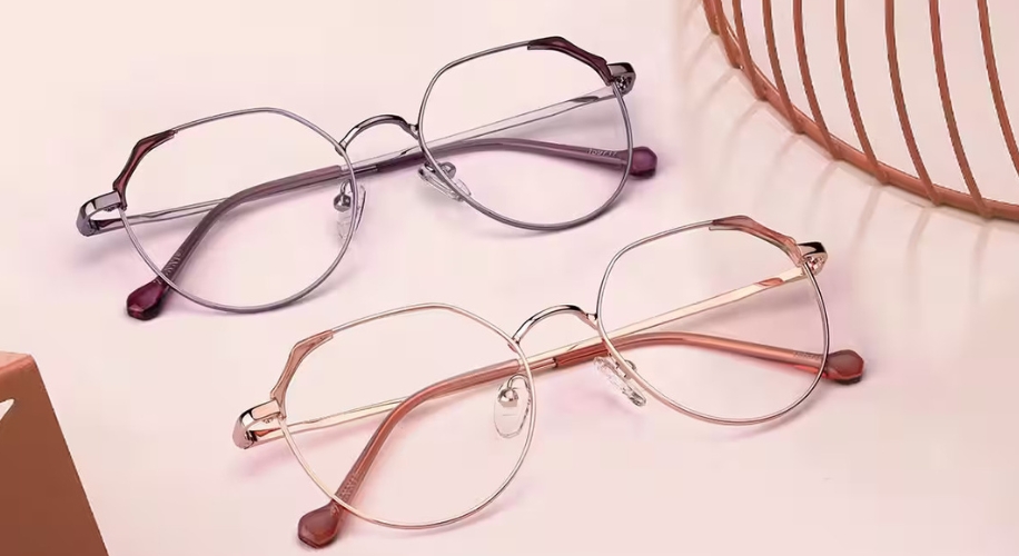 Round metal glasses frames in silver and rose gold with pink-tinted ear tips.