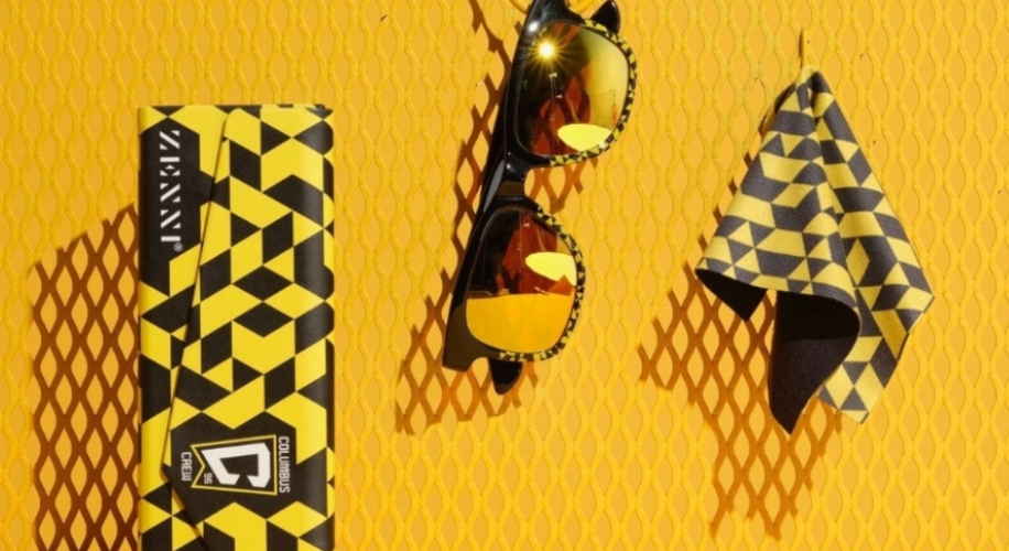 Ziennni sunglasses with geometric yellow and black design, matching case, and cleaning cloth.