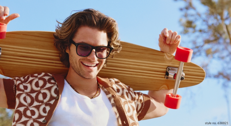 Man holding longboard with red wheels over shoulder. Text: style no. 638821.