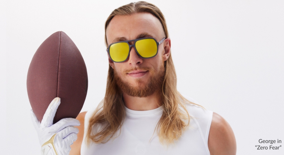 Person holding a football, wearing sunglasses with yellow lenses. Text: George in &quot;Zero Fear&quot;.