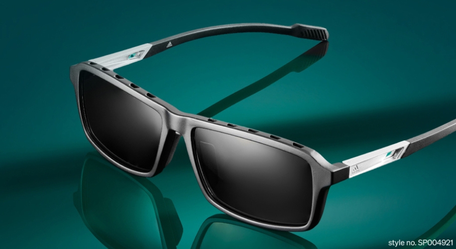 Black sunglasses with aerodynamic design, text &quot;style no. SP004921&quot; in the corner.