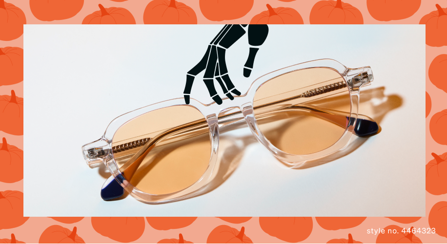 Clear frame glasses with amber lenses and style no. 4446323 on orange pumpkin pattern background.