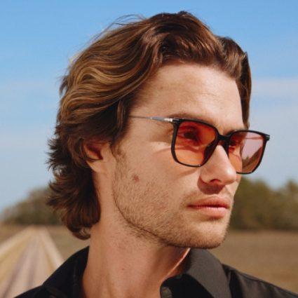 Sunglasses with brown lenses and tortoiseshell frame. Text: Chase Stokes in "Longboard".