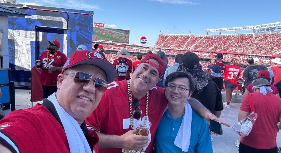 Three people in a stadium, one holding a drink. A Pepsi logo and Levi&#039;s Stadium are visible in the background.