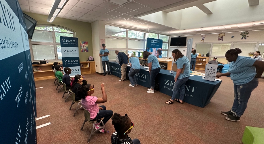 Zenni Eyewear event with tables and banners reading &quot;Eyewear for Everyone.&quot;