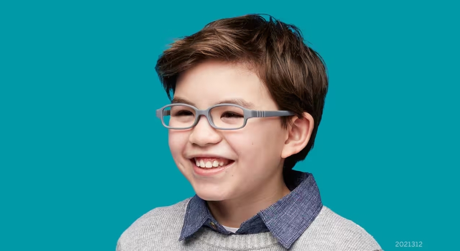 Child wearing gray-framed eyeglasses, smiling. Text in image: 2021312.