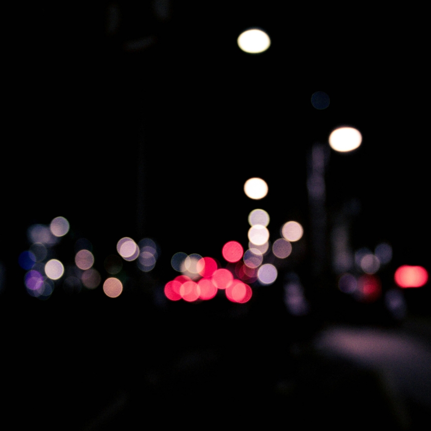 Blurred city lights with bokeh effect in various colors.