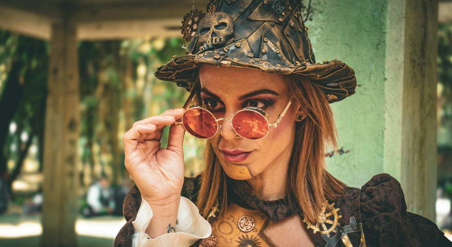 Steampunk outfit with decorated hat and goggles, detailed with gears and skull accessory.