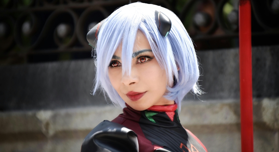 Person in blue wig and costume with black and red details.