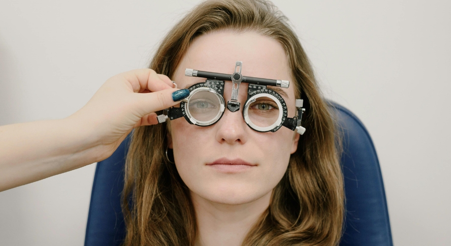 Woman wearing trial lenses for an eye exam.