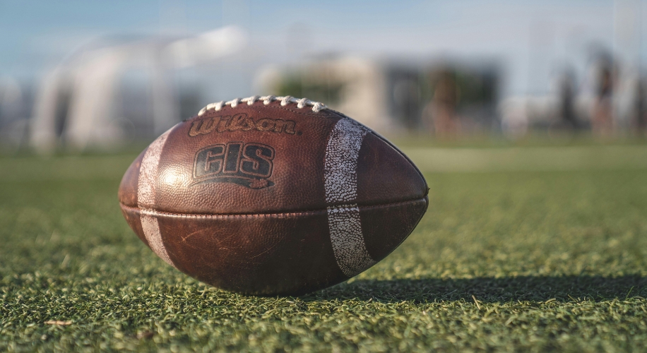 Wilson GST football on grass field.