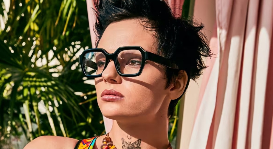 Black square-framed glasses on a person with short hair.