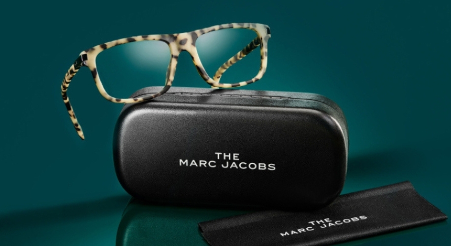 Tortoise-shell eyeglasses with case and cloth, featuring &quot;THE MARC JACOBS&quot; branding.