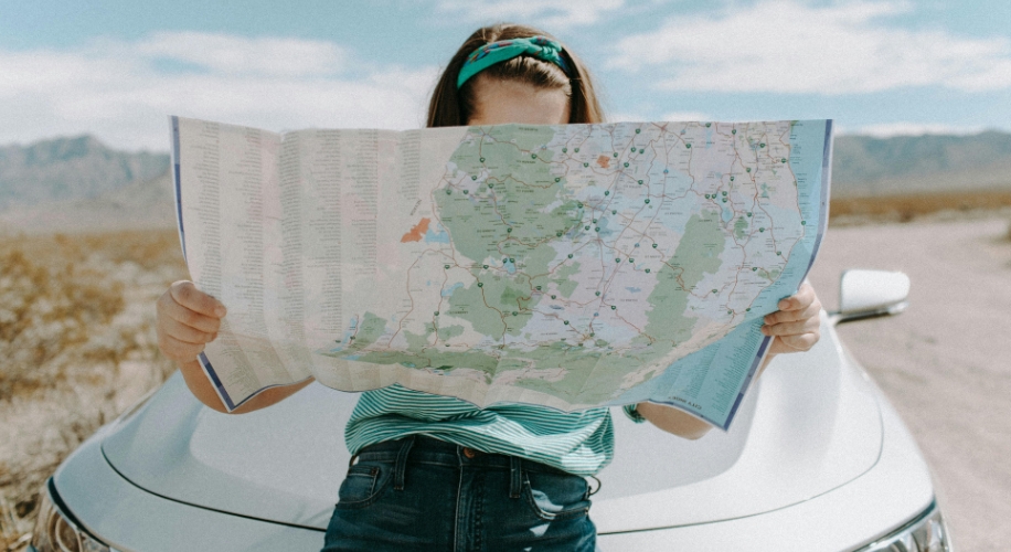 Map held by a person, showing roads and routes.