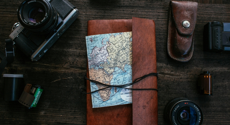 Brown leather notebook with a map tucked under black string.