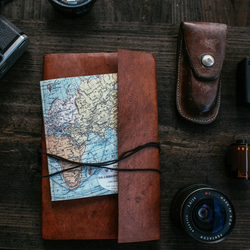 Leather journal bound with black cord, featuring a folded world map inside.