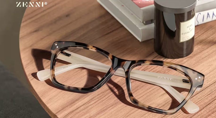 Tortoiseshell square eyeglasses with white arms, Zenni branding on the lenses and arms.