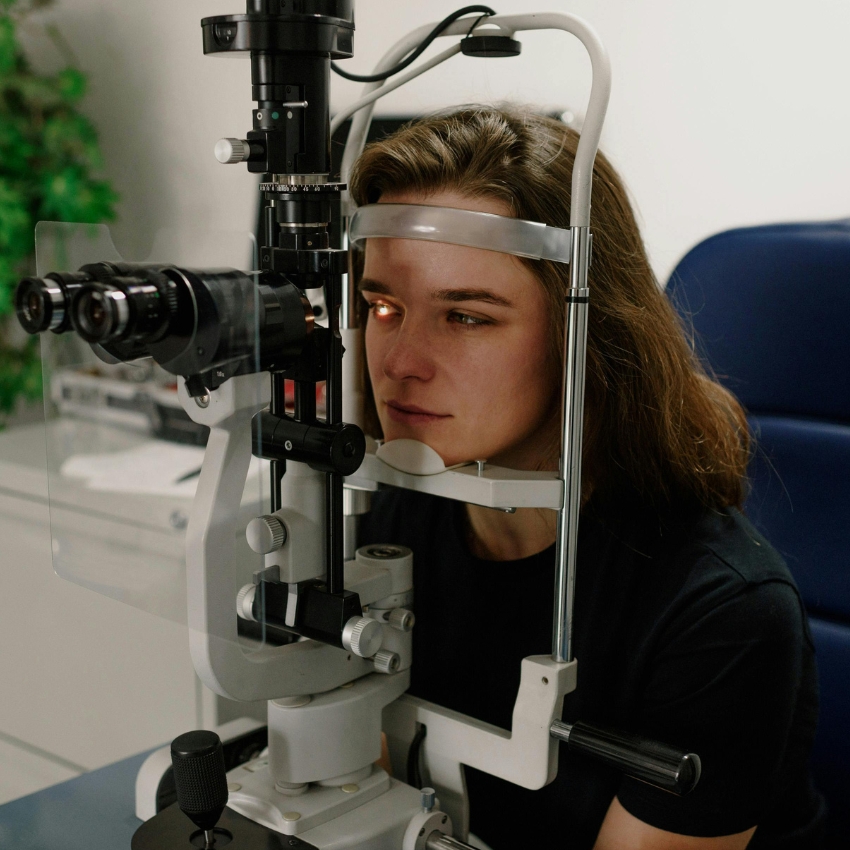 Person using an eye examination slit lamp.