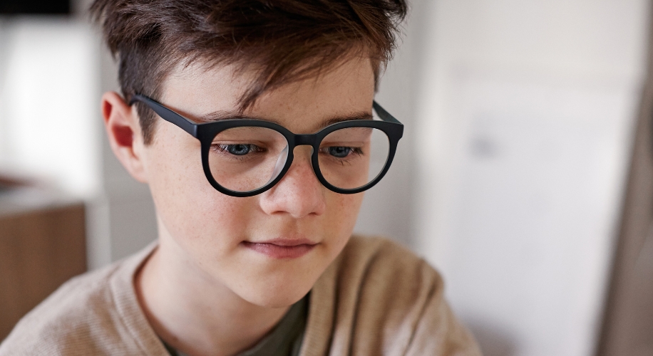 Boy wearing round black glasses.